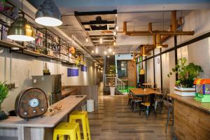 a restaurant with yellow chairs and tables in a room at The Brick in Tainan