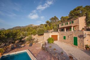 an external view of a house with a swimming pool at La Galera Deià in Deia