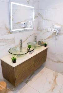 a bathroom with two sinks and a mirror at Relaxury Villa III in Karpathos