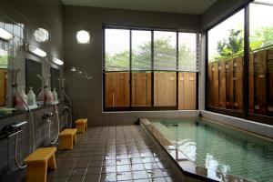 a bathroom with a swimming pool and a large window at Bunanoyado Koase in Aga +20 photos