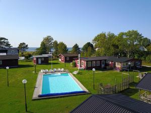 an aerial view of a backyard with a pool and houses at Strandbacka Stugor in Gnisvärd