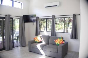 a living room with a couch and a large window at Purotu Villas in Avarua