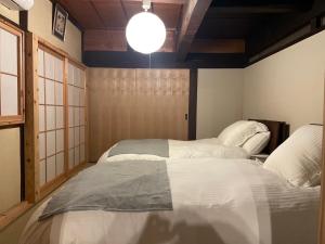 a bedroom with a large white bed in it at 陽月 Yo-Getsu in Yamaga