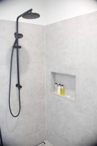 a shower with a black shower head in a bathroom at Purotu Villas in Avarua +5 photos