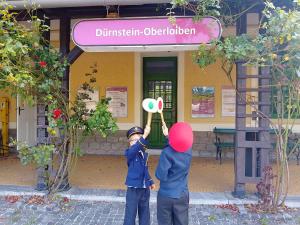 two young boys standing in front of a building at Railway cottage in Dürnstein in Dürnstein