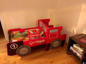 a red fire truck toy sitting on the floor at Railway cottage in Dürnstein in Dürnstein +2 photos