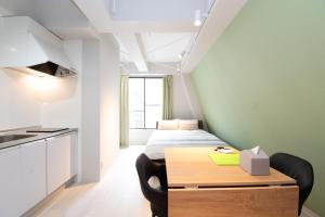 a bedroom with a bed and a desk with a table at Evergreen hotel yotsuya in Tokyo +14 photos