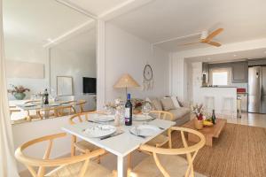 a dining room and living room with a table and chairs at Hawaii in Jávea