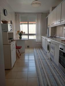 a kitchen with a sink and a dishwasher at Salvora in Bueu