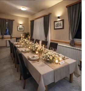 a long table with candles and flowers on it at Motel Grand in Rožaje
