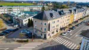 an aerial view of a city with cars parked in a parking lot at Hotel Pax in Luxembourg