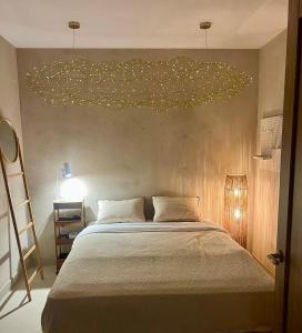 a bedroom with a large bed with lights on the wall at I Boho Sun Oceanfront Apartment in Icod de los Vinos +35 photos