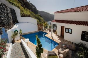 a swimming pool in the backyard of a house at I Boho Sun Oceanfront Apartment in Icod de los Vinos