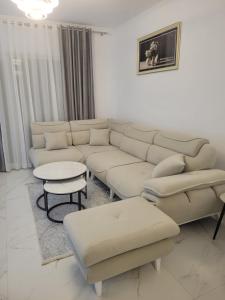 a living room with a couch and a table at Lux apartment in Kamëz +13 photos