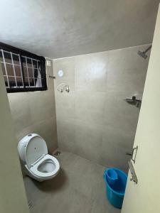 a small bathroom with a toilet and a sink at Trichy homestays in Tiruchirappalli