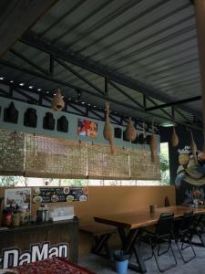 a restaurant with a table and chairs in a room at Laydaman Art Homestay in Ao Luk
