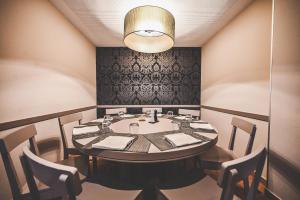 a dining room with a table and chairs at Hotel Pax in Luxembourg