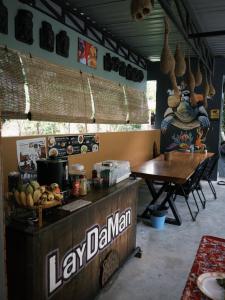 a restaurant with a table and a sign that says lay dairyman at Laydaman Art Homestay in Ao Luk