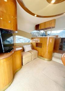 a room with a couch and a kitchen on a boat at Yacht Experience in Monaco Harbour in Monte Carlo