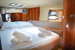 a bedroom with two rolled towels on a bed at Yacht Experience in Monaco Harbour in Monte Carlo