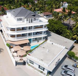 an aerial view of a white building with a swimming pool at Nyumba Maua B&B in Watamu