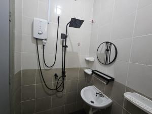 a bathroom with a shower and a sink at Razumi's Homestay 2 in Arau