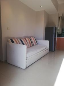 a white couch with two pillows in a living room at Suli Residences in Pesádha +24 photos
