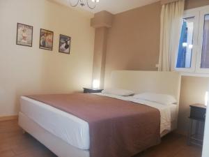 a bedroom with a large bed with two night stands at Suli Residences in Pesádha