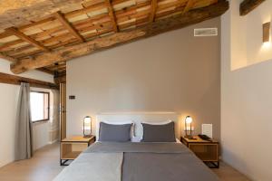 a bedroom with a large bed with two night stands at Hotel Can Cirera in Palma de Mallorca