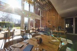 a restaurant with wooden walls and tables and chairs at Hotel Bonvino Badacsony in Badacsonytomaj