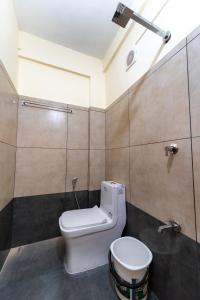 a bathroom with a toilet and a sink at SAAD Residency in Cochin