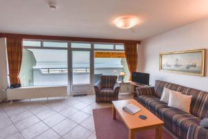 a living room with a couch and a table at Haus "Panorama" Appartement PAN024 in Duhnen