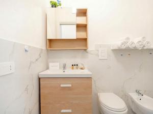 a white bathroom with a sink and a toilet at Blu Mediterraneo 2 Bedrooms & 2 bathrooms in Bari