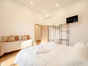 a room with two beds and a tv on the wall at Blu Mediterraneo 2 Bedrooms & 2 bathrooms in Bari