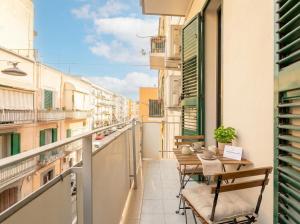 a balcony with tables and chairs on a building at Blu Mediterraneo 2 Bedrooms & 2 bathrooms in Bari