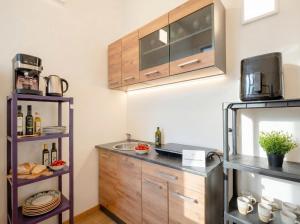 a kitchen with a sink and a microwave at Blu Mediterraneo 2 Bedrooms & 2 bathrooms in Bari +13 photos