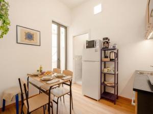 a kitchen and dining room with a table and a refrigerator at Blu Mediterraneo 2 Bedrooms & 2 bathrooms in Bari