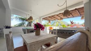 a kitchen with a table with a vase of flowers on it at Nyumba Simba House - Luxury Villa in Watamu