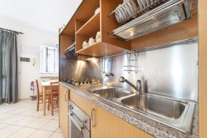 a kitchen with a stainless steel sink and a counter at Hotel Casa Cigliano in Forio d'Ischia