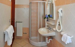 a bathroom with a shower and a sink and a mirror at Hotel Casa Cigliano in Forio d'Ischia