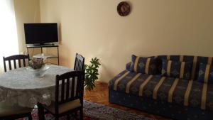een woonkamer met een tafel en een bank bij Guest House Margarita in Pomorie