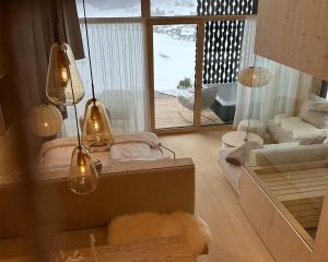 a living room with a view of a balcony at Anton & Cilli Hideaway Lodges in Obermaiselstein +81 photos