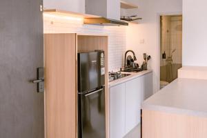 a kitchen with a refrigerator and a sink at Orbit House in Bandung