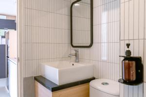 a bathroom with a sink and a toilet at Orbit House in Bandung +40 photos