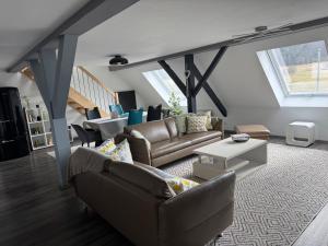 a living room with couches and a table at AlbLoft in Meßstetten