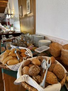 a table topped with baskets of bread on a counter at Glocke Weingut und Hotel in Rothenburg ob der Tauber