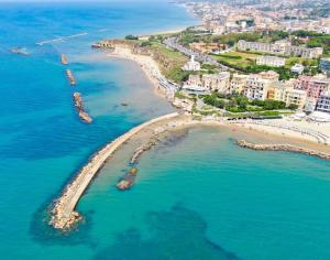 an aerial view of a beach and the ocean at LIGEA APARTMENT - Bright Mediterranean Home with Bali-Inspired Touches - Central Anzio near Sea, Train and Bus Station in Anzio