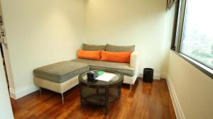 a living room with a couch and a table at The Quarter Saladaeng by UHG in Bangkok