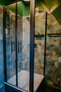 a shower with glass doors in a bathroom at sleepArt cream in Celle +47 photos
