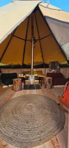 a large tent with a large rug in the middle at Tipi Mountain Camp in Sorsele